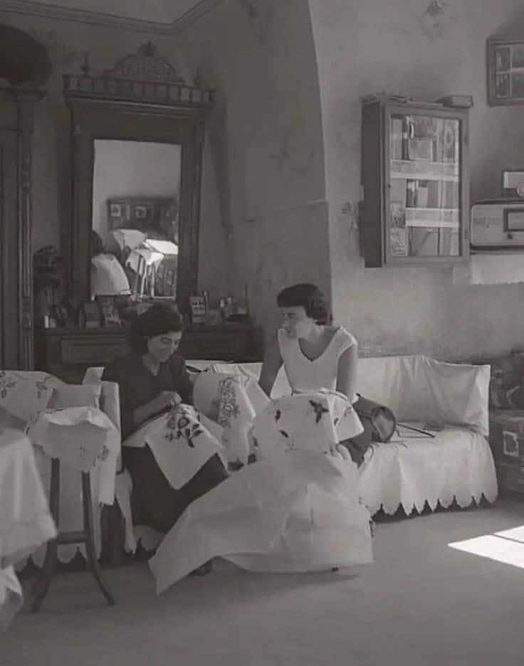 سيدتان تقومان بالتطريز في منزلهم بمدينة عكا - فلسطين 1940  | موسوعة المخيمات الفلسطينية